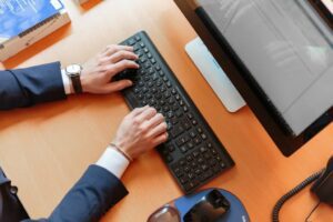 man typing on keyboard