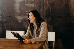 smiling woman holding notebook