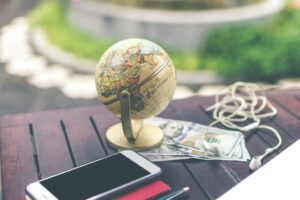 globe, mobile and money on the table