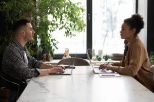 man and woman are working from home and talking