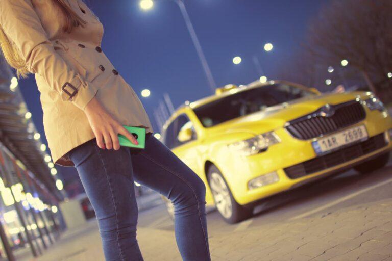 woman in front of yellow car