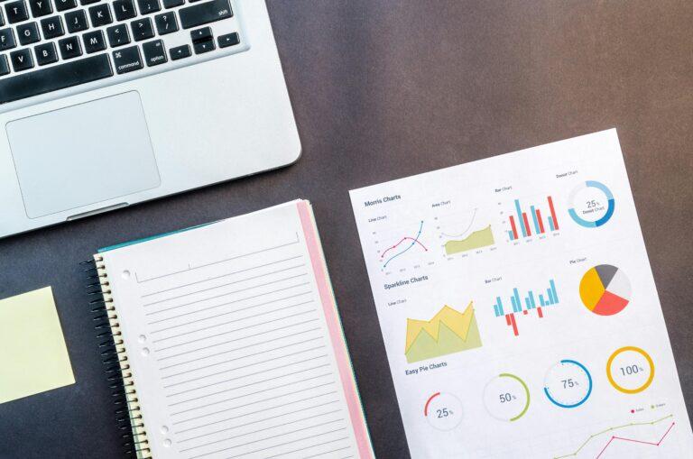 laptop, notebook and charts on a table