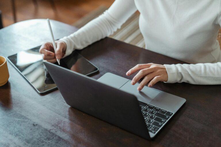 a woman is working on her laptop